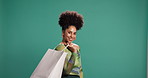 Face, shopping bag and happy woman in studio for fashion, sales and discount on background space. Smile, shopaholic and African customer with gift for Black Friday, retail therapy and promotion