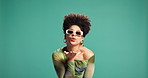 Blow a kiss, fashion and sunglasses with black woman on green background for valentines day. Flirting, love or shades with happy person in studio for affection, emoji or hand gesture of romance