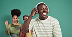 Group, dancing and man with headphones, studio and listening to song with tech, streaming or online. Happy, Dj and African people with earphones for music, green background or audio for entertainment