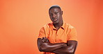 Black man, studio and shaking head or disappointed on orange background with regret, fail or no. Body language, male person and space for frustrated, doubt and negative gesture with arms crossed