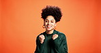 Success, fist pump and face with woman in studio for cheering, news and announcement. Promotion, giveaway and celebration with person on orange background for reward, achievement and yes gesture