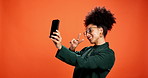 Happy, woman and selfie with peace sign in studio for social media post, fashion blog and memory. Influencer, african person and blow kiss with photography for profile picture on orange background