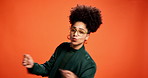 Dance, energy and face with black woman on wall background for celebration, music or party. Afro, glasses and rhythm with smile of happy African person in orange studio for expression as dancer