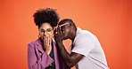 Friends, gossip and people share secret in studio on orange background and space. Conversation, rumor and surprise whisper in ear with shocked woman, man and discussion discount or sale announcement