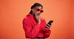 Woman, sunglasses and thinking with phone in studio for text solution, response idea or aha moment. Mockup, fashion and black person with smartphone for social media inspiration on orange background