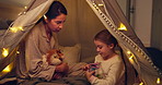 Tent, mother and child play with toy dinosaur, miniature model and bonding together in family home. Mom, parent and daughter with stuffed animal for game, learning or explain reptile species at night