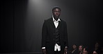 Man, model or runway with dress for fashion show, garment collection or designer brand. Male person, crowd or audience with clothing line or outfit for style publicity or fashionable trend on walkway