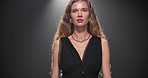 Fashion, walking and woman on runway with designer brand, clothes and outfit at showcase event. Aesthetic, catwalk and model on a stage for couture collection, trendy style and luxury wardrobe