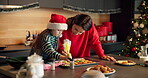 Kid, mother and piping cooking for Christmas decoration, icing skills and sweet treats in kitchen. Child, woman and help with baking, festive preparation and Santa snacks by bonding together at house