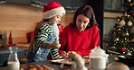 Girl, mom and piping cookies for Christmas decoration, icing skills and sweet treats in kitchen. Child, woman or helping with baking, festive preparation and Santa snacks by bonding together at house