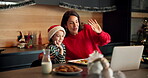 Christmas, video call and laptop with mother and daughter for wave, festive season and streaming. Xmas holiday, celebration and greeting with woman and child in family home for vacation and support