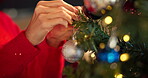 Christmas, hands and woman with ornament on tree for festive season, decoration and tradition. Bokeh, person and preparation with bauble for holiday celebration, xmas party or creative design in home