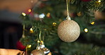 Decoration, ornaments and Christmas tree in home for festive, tradition or celebration. Glitter baubles, sparkle and xmas aesthetic with detail at holiday event or party in living room at house.