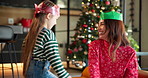Christmas, gift and hug with mother and daughter for love, festive season and bonding. Merry xmas holiday, celebration and present with woman and child in family home for vacation, care and support