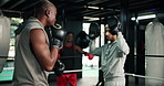 Coach, boxing and men with gloves for practice, active or training for self defense, fitness or gym. Boxer, fight and preparation for competition, personal trainer and battle with athlete for sport