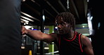 Boxing, sports and black man in gym for workout, cardio or training for MMA fight with challenge. Strong, exercise and African male athlete with power punching for self defense at fitness center.