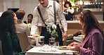 Date, couple and waiter with dish in restaurant for customer service, food and fine dining. Honeymoon, talking and server with man, plate and woman at romantic dinner for order, hospitality and love