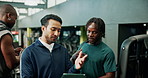 Conversation, man and personal trainer with tablet in gym for planning of training program. Advice, consulting or exercise with client and fitness coach in club for development of workout schedule