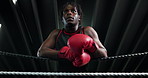 Fitness, boxing ring and man on rope for rest, relax or getting ready for challenge with low angle. Black person, tired boxer and break in gym with breathing, fatigue or motivation for fight or sport