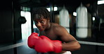 Boxing, gloves and face of black man in gym with fitness, self defense or training for match. POV, knockout and portrait of African boxer with power punching practice for workout in sports center.