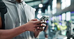 Person, hands and typing with phone at gym for workout schedule, app or tracking performance. Active, user and research with mobile smartphone for fitness tips, help or sport routine at health club