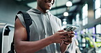 Athlete, hands and man with phone at gym for workout progress, chat notification or training app. Fitness, person and sports bag with smartphone at health club for exercise tracking or social media