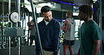 Man, fitness and coach with demonstration on cable pulley machine for arm exercise or workout. Male people, instructor and helping customer with training technique for triceps, reps or tips at gym