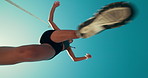 Woman, fitness and jump with blue sky below for running, exercise or athletic sport in nature. Low angle, female person or runner with hurdle in sprint, race or marathon for workout or training
