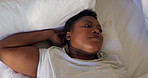 Above, thinking and black woman in bed, tired and depression with insomnia, relax and overwhelmed. African person, home and sad with mental health, comfort and exhausted with fatigue and burnout