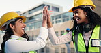 High five, women and construction workers on site with tablet for maintenance plan with goal. Happy, celebration and female civil engineers with technology for building, repairs or renovation.