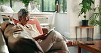 Laugh, senior woman and reading book in home for funny story,  info or literature. Sofa, elderly and happy person with novel for fiction bestseller, peace or relax with hobby for humor in retirement
