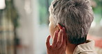 Deaf, senior woman and hearing aid in home for medical prescription, restore sound and healthcare. Retirement, old person with disability and cochlear implant device for tinnitus and acoustic tumor