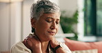 Mature woman, shoulder pain and sofa in home with stress, massage and muscle fatigue in living room. Person, sore joint and frustrated with ache, burnout and injury on couch in lounge at apartment