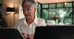 Laptop, remote work and mature woman with tablet for editing draft or ebook in home office. Computer, freelancer and check email for review, writing story and author reading publication on internet