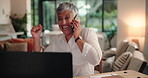 Fist pump, laptop and phone call with freelance woman at desk in living room of home for remote work. Communication, computer and success with mature person in apartment for celebration at night