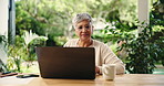 Glasses, laptop and remote work with mature woman in home office for small business research. Coffee, computer and reading with freelance employee searching information in apartment for startup job