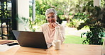 Laptop, remote work and thinking with mature woman in home office for small business research. Coffee, computer and reading with freelancer person searching information in apartment for startup job