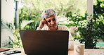 Senior woman, laptop and thinking at house with budget stress, financial crisis and payment fail. Elderly person, worry and online for loan application, mortgage bills and review expenses in backyard
