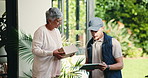 Courier, mature woman and box at front door with tablet, app and happy with e commerce at house. Delivery man, customer and smile for shipping service, package and thanks for online shopping order