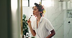 Woman, mirror and roller for skincare in bathroom for getting ready, beauty and natural treatment. Person, reflection and cosmetic tools of facial massage, lymphatic drainage and dermatology at home
