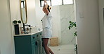Woman, haircare and dance with mirror in bathroom for morning, makeover or routine in home. Smile, phone and excited with foam hair curling rods in apartment for hairstyling, getting ready and date