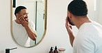 Mirror, skincare and man with beard in bathroom for grooming, hygiene or  wellness in morning routine. Happy, reflection and person with moisturizing oil for facial hair, fresh cut and health in home