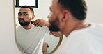 Man, morning or shaving beard on mirror in bathroom for routine, grooming or facial care. Hair removal, beauty or person in home with electrical machine for dermatology, skincare or cleaning hygiene