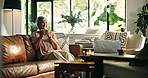 Drinking coffee, thinking and senior woman in home for peace, calm or mindset to relax on sofa. Living room, tea cup and happy person with reflection, vision or thoughts for daydreaming in retirement