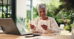Calculator, paper and old woman with laptop for finance, debt free or happy for savings. Receipt, counting and person in retirement for budget, investment and positive credit score in home backyard