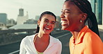 Laughing, friends and women in city for exercise, marathon training and workout. Happy, sports and people rest, relax and on break in urban town for fitness, running and health in morning together