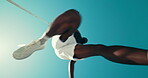 Athlete, jump and below blue sky for running, challenge or sports competition outdoor with space. Male sprinter, runner or legs in low angle for movement, exercise or fitness with fast pace or leap