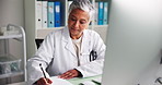 Computer, doctor and woman in office, writing and research for diagnosis, specialist and email. Mature person, medical and professional in workplace, pc and report for illness, expert and schedule