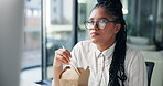 Business, woman and eating by computer in office for working break, research or productivity. Hungry, african person and ramen noodles takeout at desk for lunch meal, nutrition or reading information