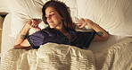 Wake up, above and woman in bedroom with stretching, calm and dreaming on bed with pillow in apartment. Sleep, relax and cozy rest on mattress with tired, morning peace and weekend break in house